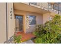 Condo entrance with door, tiled flooring, and lush plants at 1034 Bowsprit Ln, Holiday, FL 34691