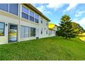 Back exterior view showing a canal and lush green landscaping at 1034 Bowsprit Ln, Holiday, FL 34691