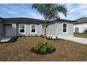 New gray house with palm tree and gray pavers walkway at 10402 Pendleton Ave, Englewood, FL 34224