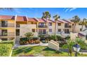 Attractive condo building with lush landscaping and palm trees at 7520 Sunshine Skyway S Ln # 110, St Petersburg, FL 33711