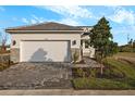 House exterior featuring a two-car garage and well-manicured landscaping at 11294 Boundless Ter, Venice, FL 34293