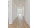 Bright hallway with light hardwood floors and recessed lighting at 1578 Running Tide Pl, Sarasota, FL 34240