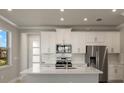 Modern kitchen with white cabinets, stainless steel appliances, and quartz countertops at 11267 Boundless Ter, Venice, FL 34293