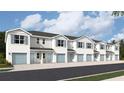 Row of modern townhomes with attached garages and coordinated shutters, creating a cohesive street view at 4592 Stargazer Ct, Palm Harbor, FL 34683