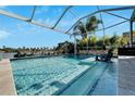 Inviting swimming pool with screened enclosure and lake view at 5205 Covesound Way, Apollo Beach, FL 33572