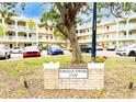 Well-maintained Hawaiian Towers condo building showcasing colorful parked cars and lush landscaping on a sunny day at 2330 Ecuadorian Way # 30, Clearwater, FL 33763