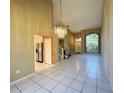 Open living and dining area with tile floors and a chandelier at 3619 Springville Dr, Valrico, FL 33596