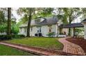 Brick home with a side yard pathway and mature trees at 37439 Meridian Ave, Dade City, FL 33525