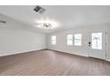 Spacious living room featuring hardwood floors and a modern light fixture at 9126 109Th Ter, Seminole, FL 33777