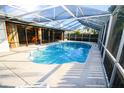 A screened-in pool area offers a refreshing escape with ample space for relaxation and entertainment at 1388 S Hercules Ave, Clearwater, FL 33764
