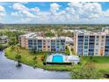 Aerial view of a condo community with pool, landscaping, and water features at 4530 Pinebrook Cir # 309, Bradenton, FL 34209