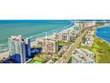 Aerial view of beachfront property with pool and tennis court at 1480 Gulf Blvd # 1107, Clearwater Beach, FL 33767