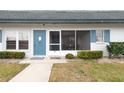 Neat exterior of a single-story home featuring a screened porch and blue shutter accents at 4444 Swift Rd # 20, Sarasota, FL 34231