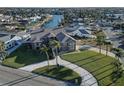 Aerial view showing a two-story house, a large yard, and a waterfront location at 1020 Bal Harbour Dr, Apollo Beach, FL 33572