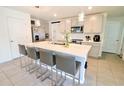 Modern kitchen with island, stainless steel appliances, and grey cabinets at 12113 Water Ash Pl, Riverview, FL 33569