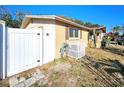 A yellow single-story home with a white fence and side yard at 7521 Coventry Dr, Port Richey, FL 34668