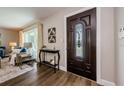 Inviting entryway with a dark wood door and stylish console table at 833 Leeward Way, Palm Harbor, FL 34685