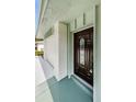 Dark wood front door with a glass insert, adding curb appeal at 833 Leeward Way, Palm Harbor, FL 34685