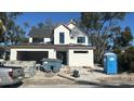 Two-story modern farmhouse under construction with gray roof and white exterior at 307 W West St, Tampa, FL 33602