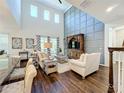 Spacious living room with hardwood floors and a large TV at 5935 Maidenstone Way, Palmetto, FL 34221