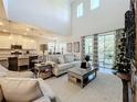 Open living room with hardwood floors, white cabinets, and island at 5935 Maidenstone Way, Palmetto, FL 34221