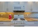 White appliances and granite countertops in the kitchen at 6060 Shore S Blvd # 601, Gulfport, FL 33707