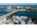 Aerial view of waterfront property near marina, bridge, and other buildings at 141 94Th Ave, Treasure Island, FL 33706