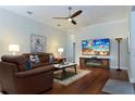 Spacious living room with a large TV, fireplace, and hardwood floors at 16303 Royal Park Ct, Tampa, FL 33647