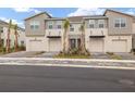 Attractive townhome community featuring gray exteriors and paver driveways at 31471 Woodland Race Loop, Wesley Chapel, FL 33545