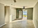 Bright living room with tile floors and door leading to backyard at 4732 W Lawn Ave, Tampa, FL 33611