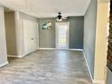 Living room with grey walls, tile floors, and access to backyard at 4732 W Lawn Ave, Tampa, FL 33611