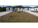 Newly constructed duplex with gray exterior and paved driveways at 10334 Pendleton Ave, Englewood, FL 34224