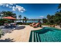 Inviting pool and patio area with water views at 118 Harbor View Ln, Belleair Bluffs, FL 33770