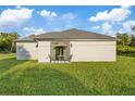 Newly built home with patio and grassy backyard at 12114 Clarendon Ave, Port Charlotte, FL 33981