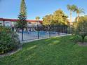 Another view of the community pool, showing its size and surrounding greenery at 1753 Belleair Forest Dr # F3, Belleair, FL 33756