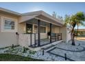 Charming ranch home with covered porch and stone accents at 1866 Venetian Point Dr, Clearwater, FL 33755