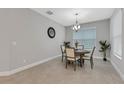 Dining room with a round table, four chairs, and a large window at 4735 Avila Lakes Dr, Wimauma, FL 33598