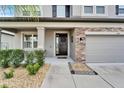 Inviting front porch with stone accents and a black front door at 11411 Alachua Creek Ln, Riverview, FL 33579