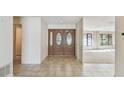 Inviting foyer with tile flooring and elegant double doors with decorative glass inserts at 4617 Westford Cir, Tampa, FL 33618