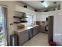 Modern kitchen featuring white and gray cabinets and quartz countertops at 12705 Longcrest Dr, Riverview, FL 33579