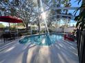 Inviting screened pool with patio furniture and umbrella at 12705 Longcrest Dr, Riverview, FL 33579