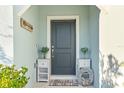 Charming home front door with a welcome mat, elegant decorations, and tasteful accents at 30399 Marquette Ave, Wesley Chapel, FL 33545