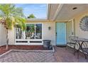 Inviting front entry with light teal door and brick pavers at 9830 Mark Twain Ln, Port Richey, FL 34668