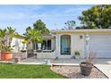 Inviting home exterior featuring a landscaped lawn and charming entryway at 9830 Mark Twain Ln, Port Richey, FL 34668