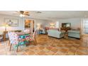 Bright living room featuring terracotta tile floors and comfy seating at 9830 Mark Twain Ln, Port Richey, FL 34668