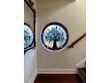 Circular stained glass window depicting a tree, adding a unique artistic touch at 6211 S Macdill Ave # 1, Tampa, FL 33611