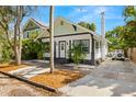 Charming bungalow with a white exterior, landscaping, and a driveway at 554 6Th N Ave, St Petersburg, FL 33701