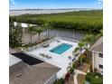 Community pool with lounge chairs and waterfront view at 8814 Bay Pointe Dr # 204, Tampa, FL 33615