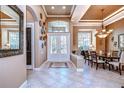 Elegant dining room features a chandelier, large windows, and a decorative wall at 20953 Broadwater Dr, Land O Lakes, FL 34638