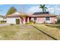 Pink house with solar panels and a spacious yard at 7853 Sundown Dr, St Petersburg, FL 33709